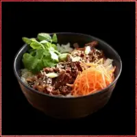 Wagamama Beef Teriyaki Donburi — sliced beef glazed with soy and sesame sauce, served on steamed rice with greens.