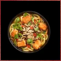 Wagamama Spicy Tofu Udon — udon noodles with crispy tofu in a mild chilli sauce, vegetables, and spring onions.